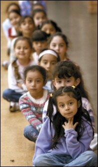 First graders wait to go back to their dual language classroom at Northwest Elementary School in Dodge City, Kan.