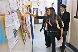 Shamael Daftagir, 16, and Muhammad Hussain, 17, right, gather information as they leave a job fair sponsored by South Asian Youth Action in New York City on May 13. The group organizes education programs and leadership activities on a variety of issues, including immigration policy, for students of South Asian heritage.