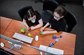 Second graders Sarah Puddu, left, and Cristalee Valdez create a stop-motion movie with modeling clay and a computer during a SHINE after-school program at the Lawrence B. Morris Elementary School in Jim Thorpe, Pa. President Donald Trump’s proposed budget would eliminate the 21st Century Community Learning Centers program, from which SHINE receives 82 percent of its funding.