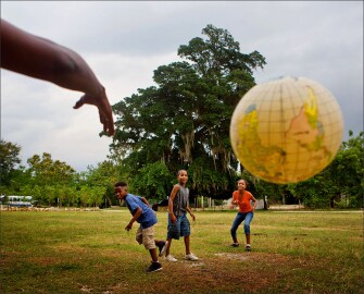 Young children, including VLA student Jevron Hobbs Jr., at left, bridge the language divide with the global language of sport outside of the Pomier Caves Anthropological Reserve north of San Cristobal in the Dominican Republic.