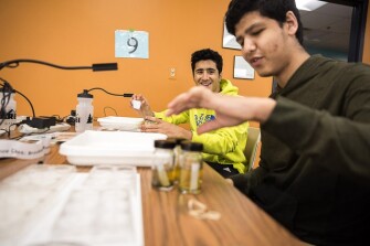 Tavan Zadeh and Zane Aridi, both seniors at Dexter High School, in Dexter, Mich., joke around as they take part in an annual census of insects.