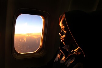 Latavia Nelson, 12, looks out the window during her first airplane flight to attend an awards banquet in Washington D.C. Latavia was chosen to represent the award-winning newspaper staff of the J.Hop Times from John Hopkins Middle School.