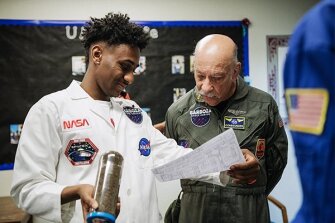 Long Beach student DJ Cruz practices taking apart a device used by astronauts as Bob Barboza, the founder and director of the Barboza Space Center, watches. Cruz is a member of the Urban Math Collaborative, a program that supports math and science enrichment for boys of color in three Long Beach high schools.