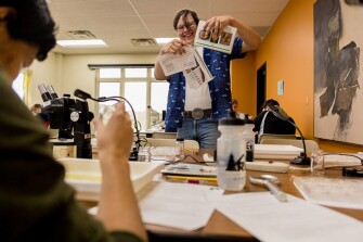 Niklas Krantz, a coordinator with the Huron River Watershed Council, laughs with students during the council’s annual “Insect Identification Day” in Ann Arbor, Mich.