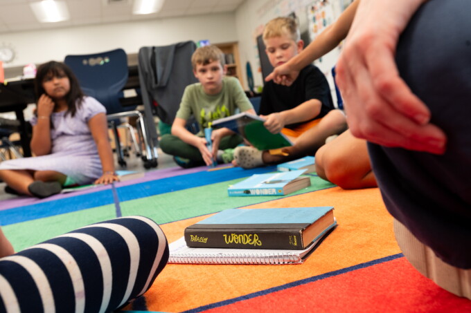 Natalia Gutierrez, age 10 (5th grade), Garrett Christian, age 10 (5th grade), William Robinson, age 8 (3rd grade), wait to begin reading time in the afternoon at Creative Minds School in Wichita, Kansas on September 15, 2026.