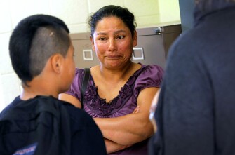 Ofelia Ajeatas listens to her son, Danny, promise he will not make her miss work again to attend peer court.