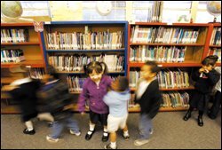 Pupils in the morning session at Baldwin Academy's pre-K program in La Puente, Calif., use the school's library for reading and interacting with other grades in the K-5 public school.