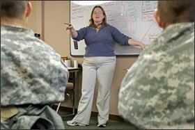 Teacher Christin Bradshaw leads an English lesson in her Army Preparatory School classroom. She works longer hours than she did in the middle school where she taught for five years, but enjoys teaching adults.