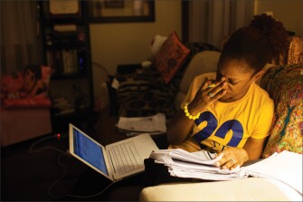 English/language arts teacher Dowan McNair-Lee fights fatigue as she grades papers in the evening at her home in southeast Washington.