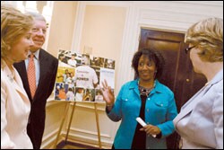 Linda Alston, center, expresses her appreciation to Nancy and Rick Kinder, left, after winning the Kinder Excellence in Teaching Award, while Margaret Spellings looks on.