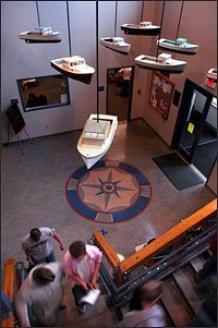 Model lobster boats by artist Diana Cherbuliez, of Vinalhaven, Maine, hang in the lobby of the Vinalhaven School, which offers an Advanced Placement art class, part of a program to boost AP enrollment.