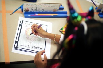 Kendall, another kindergartener in the class, draws her choice: ice cream raining down.