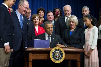President Barack Obama, flanked by Senate education committee Chairman Sen. Lamar Alexander, R-Tenn., left, and the committee's ranking member Sen. Patty Murray, D-Wash., signs the Every Student Succeeds Act on Dec. 10, 2015.