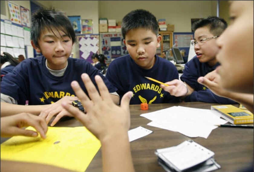 Students Xin Ron Zhou, Jin Hui Tan, Yu Chen, and Joshua Castro participate in a “math league” competition at Boston’s Edwards Middle School, which is part of an experimental program in Massachusetts that is studying the effects of providing extended time for learning.