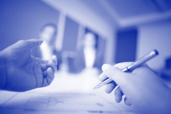 Photo of hands gesturing at a meeting.