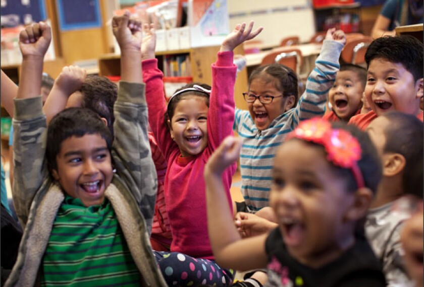 First graders react to the question "what face do you make when your mother compliments you?" with smiles of laughter and joy during a class session called "Feeling Faces" at Public School 24 in Brooklyn, N.Y. 