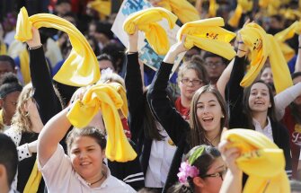 Parents, students, and administrators wave yellow scarfs as they take part in a rally in support of school choice on Jan. 24 in Austin, Texas.