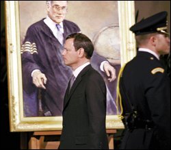 Judge John G. Roberts Jr. walks past a portrait of Chief Justice William H. Rehnquist at the U.S. Supreme Court on Sept. 6 as the late chief justice's body lies in repose nearby.