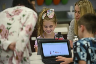 Capri Matusic, 8, shows her mom, Lorrie, her coding project at “Creative Coding: A Morning of Making” as part of a Remake Learning Days program held at South Fayette Intermediate School on May 23, 2022 in McDonald, Pa.
