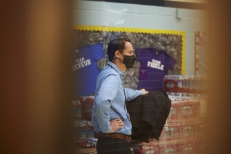 Cleveland Metropolitan School District Chief Financial Officer Derek Richey watches as students run softball drills before the first bell rings at Clark Elementary School in Cleveland, Ohio on Jan. 13, 2022.