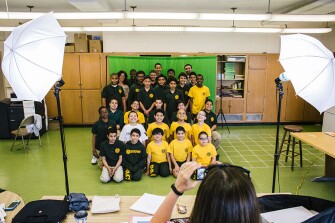 Students pose in a group portrait for their chess club.