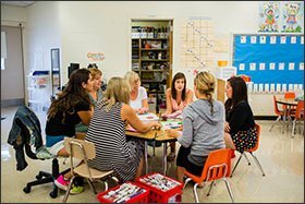Kindergarten teachers at Fallsmead Elementary School in Rockville, Md., discuss how to assign students to classrooms after the third day of classes.