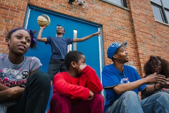 Residents from the neighborhood, nicknamed as “down the hill,” hang out at a makeshift court behind P.S. 28, in Paterson. This neighborhood is considered to be one of Paterson’s most crime-ridden and impoverished in the city.