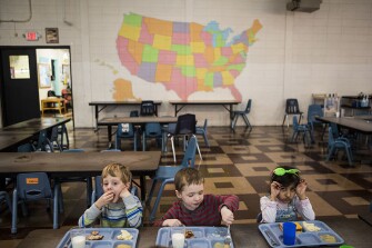 Jake Ruhl, left, Easton Bigham and Zahraa Almohanna eat lunch together at Starkville Early Learning Collaborative in Starkville, Miss.
