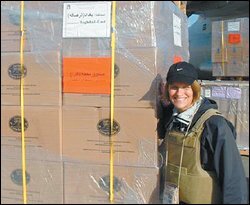 Susan Aspey of the Education Department poses near boxes of Iraqi ballots.