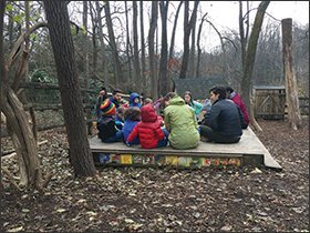 Students and teachers gather at the Audubon Nature Preschool in Chevy Chase, Md. Pupils begin their days outside, come together for a morning circle, and then head to learning centers. The day ends with a story and a hike.