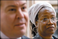 Dianne Payne listens as lawyer Eric Grannis takes questions from reporters outside the Tweed Courthouse in Manhattan. Ms. Payne asked a judge to make the state pay for her children to attend private school at the same $13,000 per-pupil funding level that New York City's public schools spend.