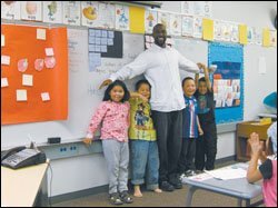 Second-year teacher John Broussard, who hails from Portland, Ore., works with his 2nd graders in Kotlik.