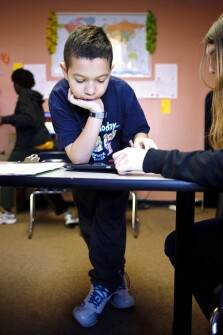 Eleven-year-old Chance Connors helps classmate Jessica Ramsey, 14, work on a writing tutorial on one of the Apple iPads in their classroom at High Road Academy of Baltimore County, West, in Dundalk, Md. Tablet computers are becoming a popular assistive-learning device in special education programs across the country. When Chance uses the iPad, he likes to practice his mathematics skills with the Math Ninja application.