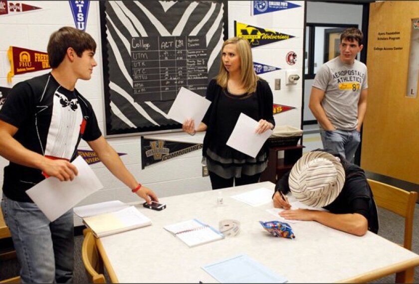 Counselor Susan Rhodes talks with Derek Watkins, left, Ian Lawrence, and Hunter Himes, all 17, in the College Access Center at Perry County High School in Linden, Tenn. Ms. Rhodes works with students and their families to overcome a basket of concerns that may inhibit those looking to attend college.