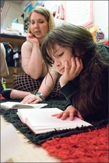 Third grader Sarah Malone reads from Treasure Island as her teacher, Meredith Starks, looks on at Bellaire Elementary in Bossier City, La. Starks is one of 75 teachers chosen by the state to write an English/language arts curriculum. She wrote three guidebooks, including the one on Treasure Island.