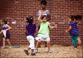 Assistant teacher Elizabeth Rollins watches children play at the Claxton- West Head Start Center, in Knoxville, Tenn. She has worked at the center for 10 years. Citing automatic budget cuts, the Knoxville- Knox County Head Start agency chose to end its service year two weeks early.