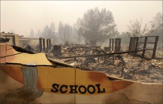 The burned remains of the Paradise Elementary school smolder in Paradise, Calif. Blocks and blocks of homes and businesses in the Northern California town were destroyed by a deadly wildfire.