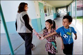 Lone Star Principal Ketti Davis greets students. Pupils at the school who need extra help can work with special education teachers, even if they are not identified for such services.