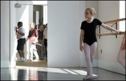 As classmates pass by, a student strikes third position at the barre during a ballet class at the Northwest Florida Ballet Academie in Fort Walton Beach, Fla.