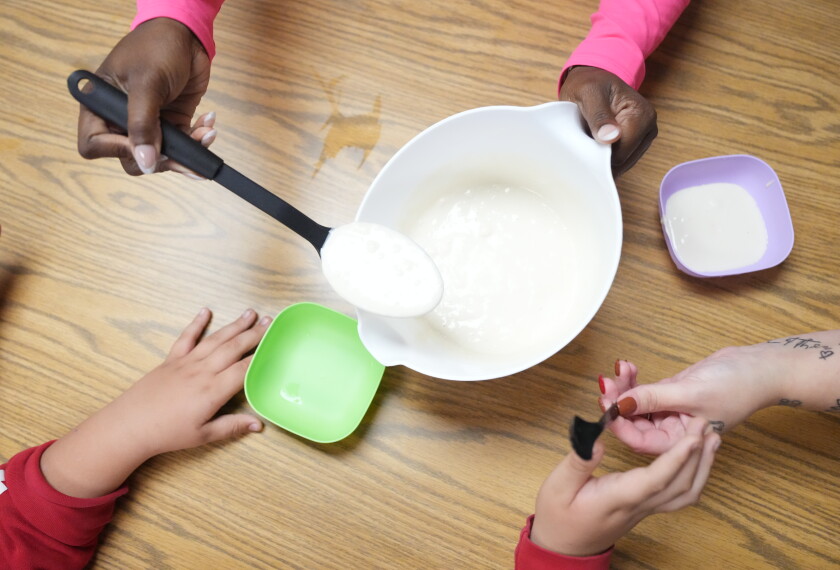 Students get waffle mix for a chicken and Waffles cooking day in the classroom of Gabrielle Carpenter at the Daniel Webster School in Indianapolis, Friday, Oct. 2, 2026.
