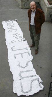 Douglas Mertz, the attorney for former Juneau-Douglas High School student Joseph Frederick, stands next to his client's "Bong Hits 4 Jesus" banner June 25, in Juneau, Alaska.
