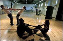 Dance students at Moore Square rehearse a routine as teacher Cindy Hoban works in the background to synchronize a computerized pattern with the movements.