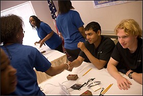The Buffalo team members greet their opponents at the science bowl before a match.