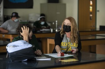Daisy Bennett, a paraprofessional who works at two schools in Orange County, Calif., poses on the campus of Brea Olinda High School in Brea, Calif. on Friday, Sept. 17, 2021.