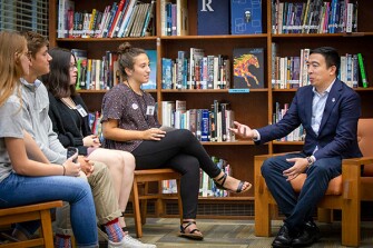 Democratic presidential candidate Andrew Yang meets with student journalists in the Roosevelt High School library.