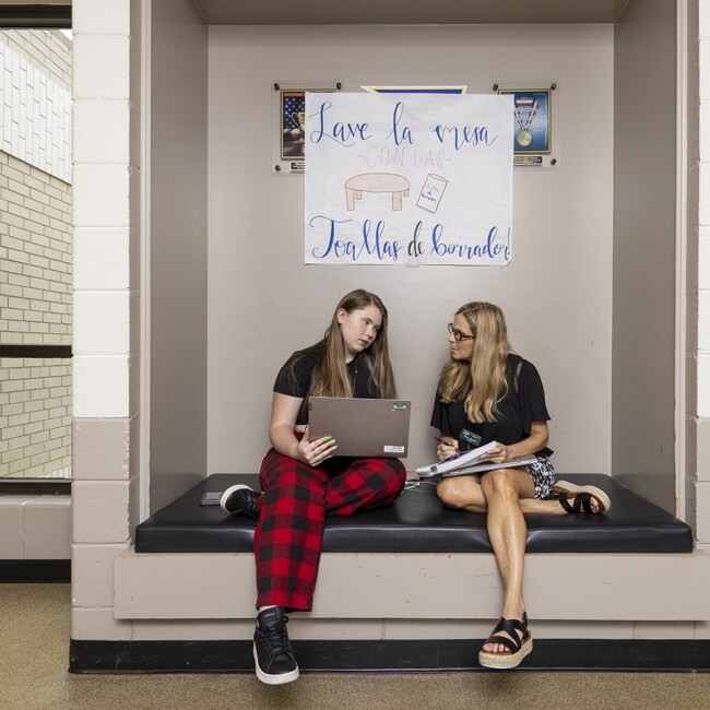 Teacher Dawn Mathis works with student Rylee Humphries, 16, during an after school program at Mountain Education Charter High School in Woodstock, Ga. The Mountain Education Charter High School system has a program that pairs struggling students with adults who have faced similar challenges.