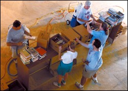 Staff members at Metairie Park Country Day clean school library books damaged in the wake of Hurricane Katrina. All but about 200 of its 31,000 books were saved.