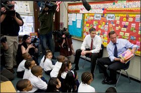 U.S. Secretary of Education Arne Duncan, left, and Maryland Gov. Martin O’Malley read New Tricks I Can Do! to a 1st grade class at Doswell E. Brooks Elementary in Capitol Heights, Md., on April 1, after the secretary announced the release of $44 billion in education stimulus funding.