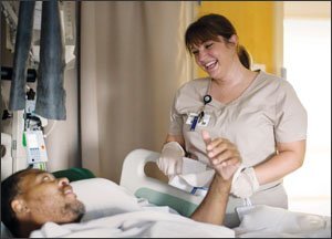 At the Oklahoma State University Medical Center, Ms. Goodman talks with patient Larry Fortenberry during her overnight shift at the hospital.