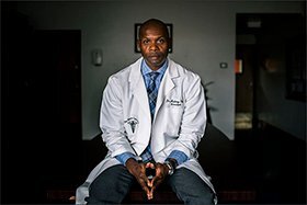 Rodney Fisher, the founding principal of the Marie Curie High School for Medicine, Nursing, and Health Professions, poses for a portrait inside the New York City school.